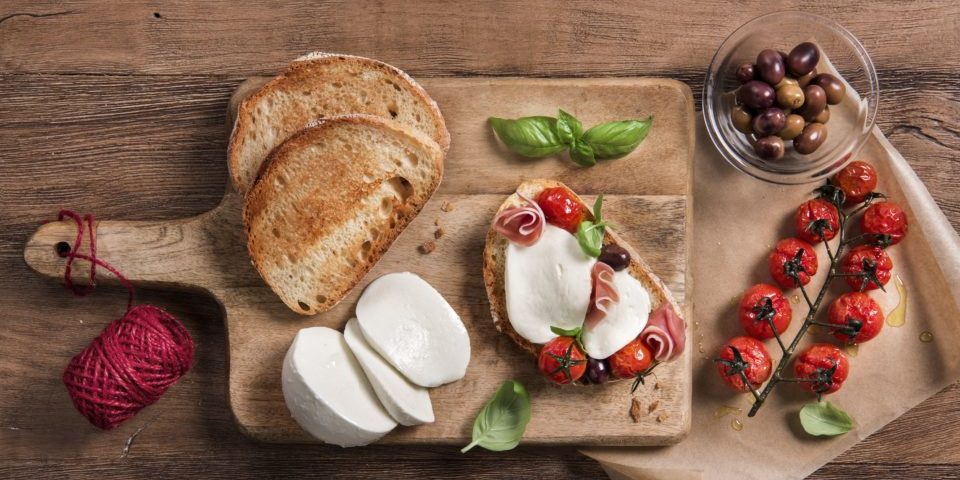 Bruschetta mit Mozzarella, Kirschtomaten, Oliven und Basilikum